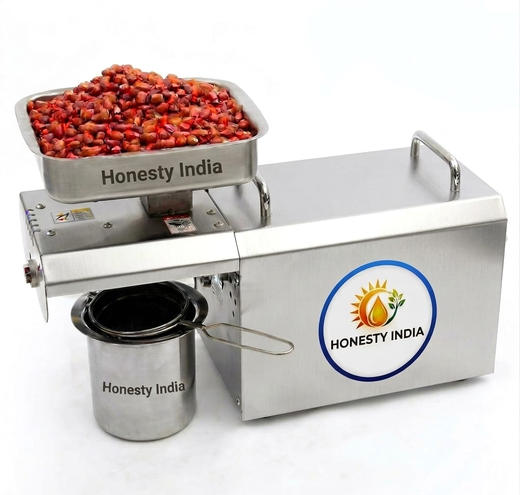 Honesty India stainless steel home oil press machine with a tray of seeds and an oil collection cup