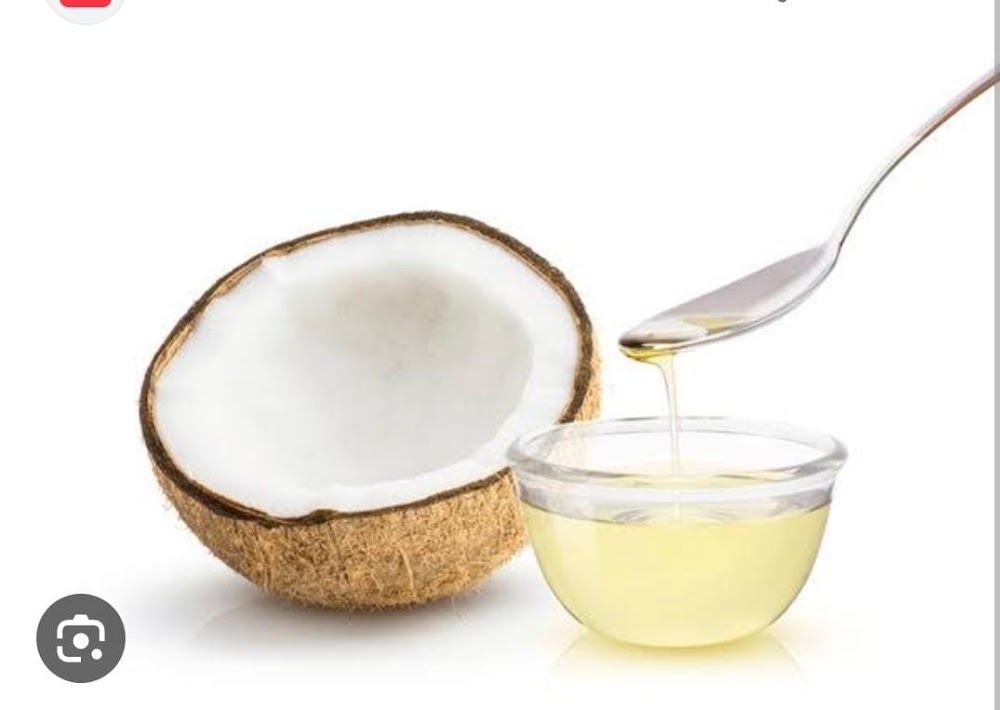 Half coconut and a bowl of coconut oil